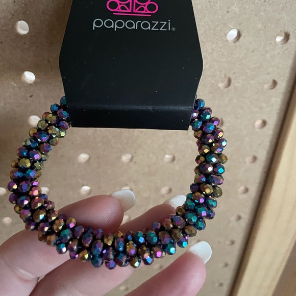 Stretch bracelet with many multicolored oil spill beads.